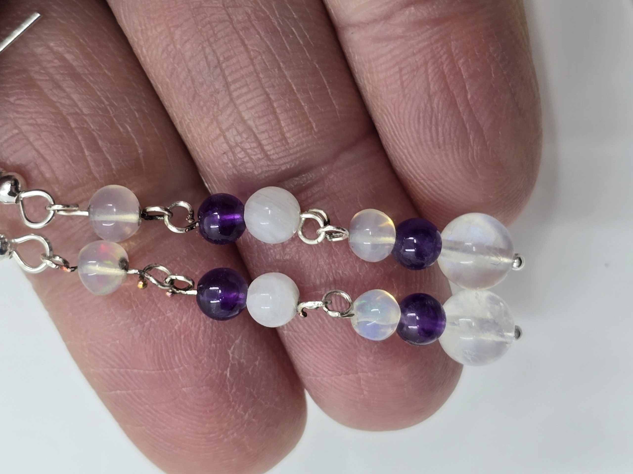 3909a2_fb647c1774024a6a9a2059cd6b427baamv2-1-scaled-1.jpg Beaded moonstone, amythist, and opal earrings - Image 1